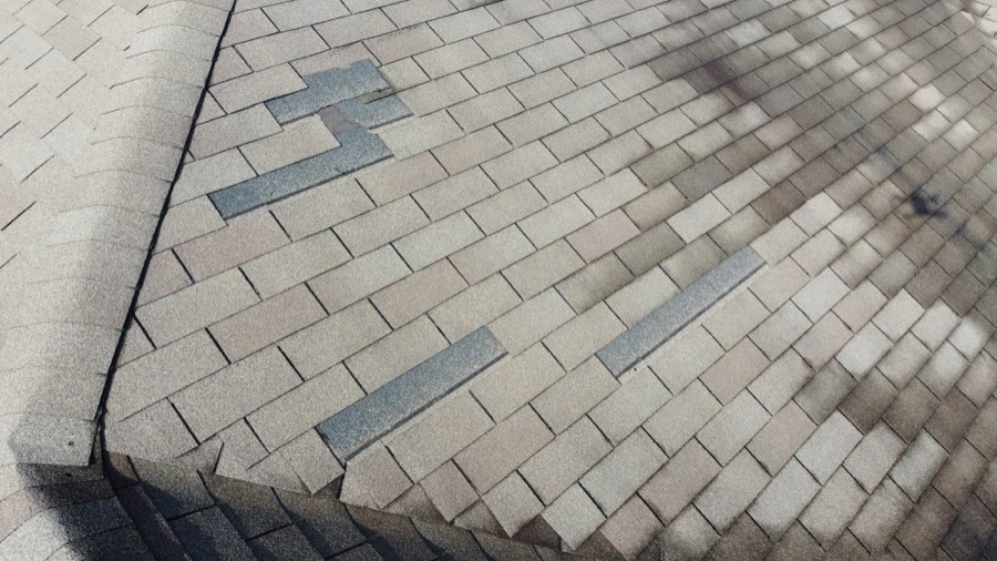 Close-up of storm-bruised shingles on a Kaufman County roof